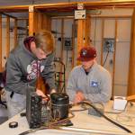LOUIS KRAUSS | THE DAILY WORLD Gage Iverson and Matthew Plato, both seniors from Montesano High School, work on a fish tank cooler during electrical engineering class at Aberdeen High School. They drive to Aberdeen in the afternoons for the class.