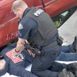 DAN HAMMOCK | THE DAILY WORLD                                An Aberdeen High School student is worked on by an Aberdeen Police officer at a staged car crash Monday morning.