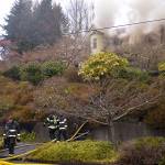 LOUIS KRAUSS | THE DAILY WORLD Firefighters walk away from a house fire on West 10th Street in Aberdeen. The occupants escaped the building without sustaining injuries.