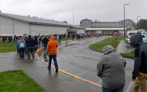 DAN HAMMOCK | THE DAILY WORLD                                Students and guests at the Ocosta School take part in a tsunami drill Wednesday afternoon. The fortified gym building, the flat-roofed building over the buses, is designed to safely hold hundreds of people and to withstand a worst-case tsunami scenario.