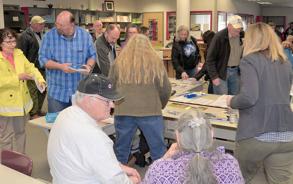 DAN HAMMOCK | THE DAILY WORLD                                Area residents packed the library at the Ocosta School Wednesday for the Tsunami Road Show, where information from several state and national sources about preparing for and surviving a tsunami was available.
