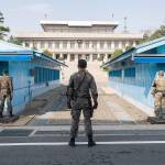 On April 18, 2018, in Paju, South Korea, South Korean soldiers and a U.S. army soldier, right, keep watch on North Korea at the truce village of Panmunjom in the demilitarized zone (DMZ) separating North Korea from the South. (Lee Jae-Won/AFLO)