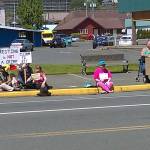 A group of protesters sits at the corner of Market and H streets in downtown Aberdeen expressing their dismay with a decision by the Aberdeen City Council on Wednesday night. (David Haerle | The Daily World)