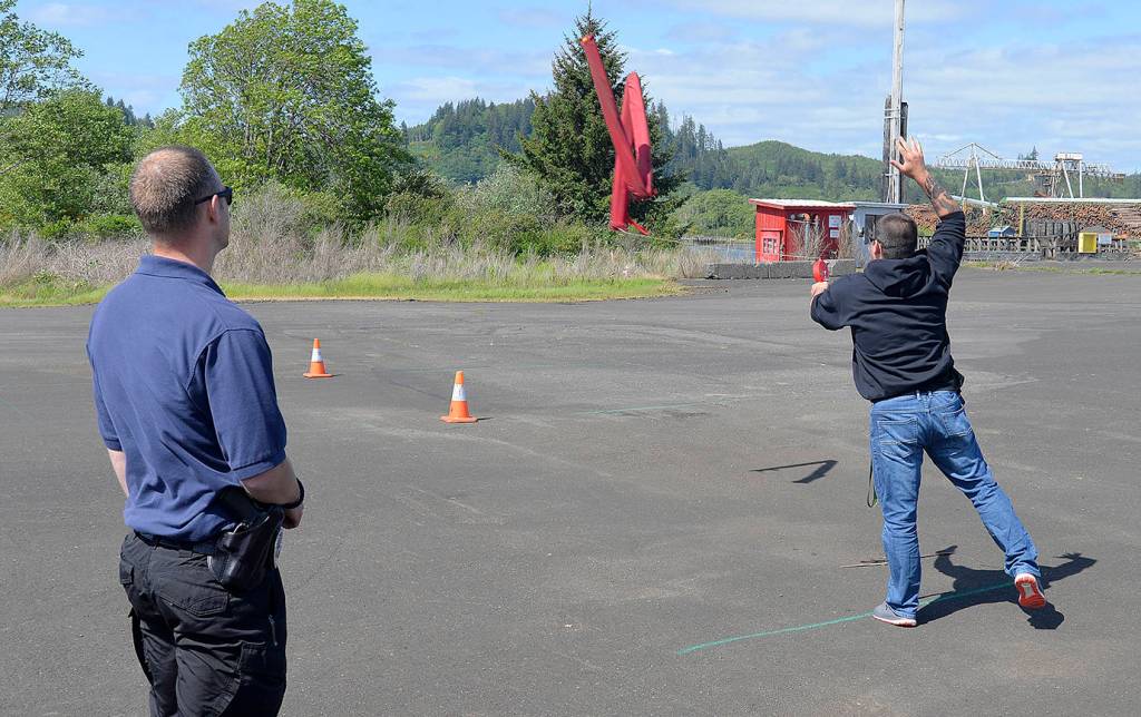 DAN HAMMOCK | THE DAILY WORLD                                The last segment of the three-hour tactical driving course taught by Montesano and Hoquiam police officers had students tossing mock spike strips after driving at high speeds with full lights and sirens around a complicated course.