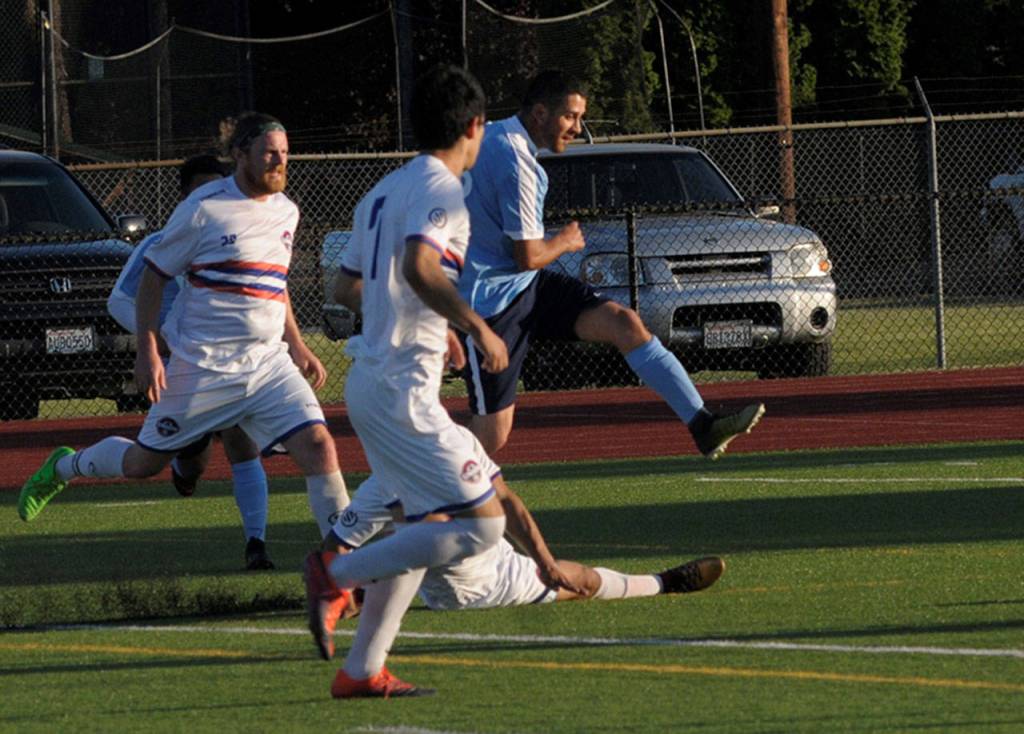 Grays Harbors Victor Garcia shoots and scores in the 18th minute of a game against Twin City on Saturday. (Hasani Grayson | The Daily World)