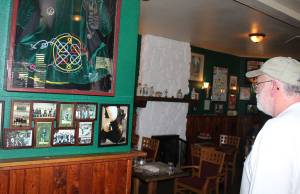 Angelo Bruscas/North Coast News Liam Gibbons looks over some of the collection of personal mementoes collected for display at Galway Bay.