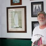 ABOVE: Galway Bay Irish Pub owner Liam Gibbons asks: Who has an autographed picture of a saint in their banquet room? Among his collection of papal portraits and other Catholic artifacts, he points to a signed photo of Mother Teresa (at bottom left).                                RIGHT: Sports memorabilia of all things Irish are displayed in the game room at Galway Bay.