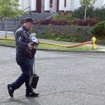 (Kat Bryant | The Daily World) Coastal Community Action Program CEO Craig Dublanko carries an armload of file backups rescued by firefighters after the blaze was out.