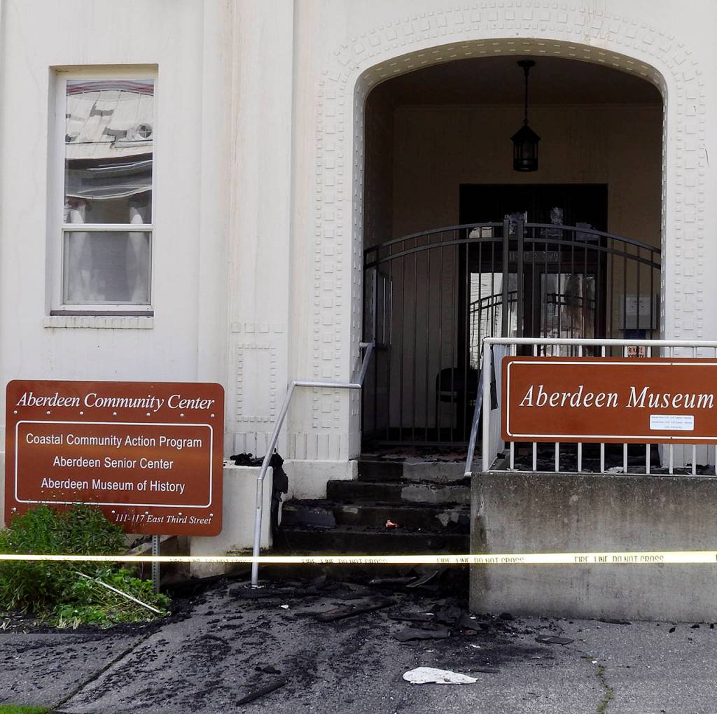 (Kat Bryant | The Daily World) The building entrance is littered with glass and charred bits.