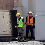 (Kat Bryant | The Daily World) Inspectors look over the damage outside the Armory on Monday.