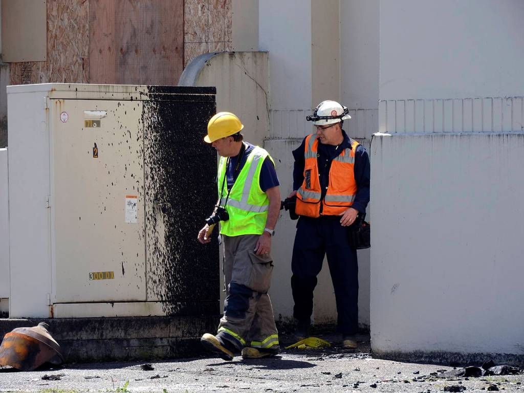 (Kat Bryant | The Daily World) Inspectors look over the damage outside the Armory on Monday.