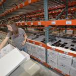 LOUIS KRAUSS | THE DAILY WORLD State archivist Maggie Cogswell stores images printed on glass sheets after theyve finished drying at the State Archives warehouse in Tumwater.