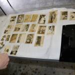 LOUIS KRAUSS | THE DAILY WORLD A volunteer lays down a photo to be dried after cleaning it at the Washington State Archives in Tumwater.