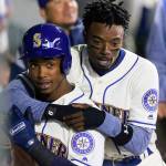 The Seattle Mariners Dee Gordon, right, hugs teammate Jean Segura in the dugout during a game in April. Segura has been out of the Mariners lineup since Thursday due to an infection. (Ken Lambert/Seattle Times/TNS)
