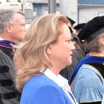 DAN HAMMOCK | THE DAILY WORLD                                Quinault Indian Nation president Fawn Sharp stands with Grays Harbor College educators watching nearly 200 students take to Stewart Field in Fridays commencement ceremony. Sharp was the speaker, and is a member of the college board of trustees and herself is a 1988 graduate of the school.