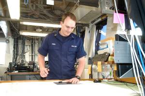 Ensign James Freed, a junior officer on the NOAA ship Bell M. Shimada, plots a course in the Olympic Coast National Marine Sanctuary while docked in Port Angeles. The crew planed to conduct surface trawls along three cross-shelf transects within the sanctuary before returning to Newport, Ore. (Rob Ollikainen/Peninsula Daily News)