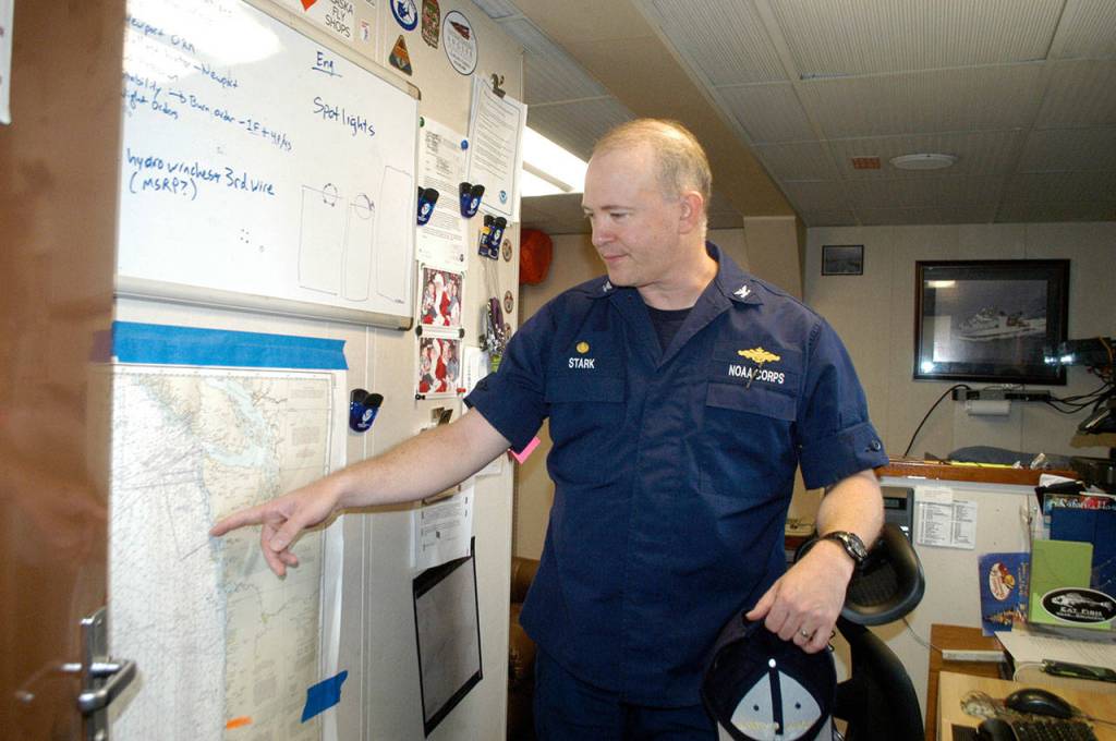 Capt. Jesse Stark, commanding officer of the NOAA ship Bell M. Shimada, reviews charts in preparation for a cruise to the Olympic Coast National Marine Sanctuary while the vessel was docked in Port Angeles. Stark is a 1990 Port Angeles High School graduate. (Rob Ollikainen/Peninsula Daily News)
