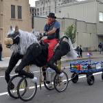 LOUIS KRAUSS | THE DAILY WORLD John Culp rides his self-made horse bicycle through the Founders Day Parade in Aberdeen.