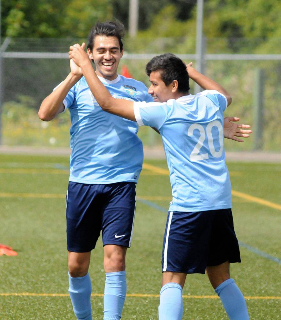 Victor Corona, left, celebrates with Victor Junco after Corona scored a goal in the first half against Twin City Union on Sunday. (Ryan Sparks | The Daily World)