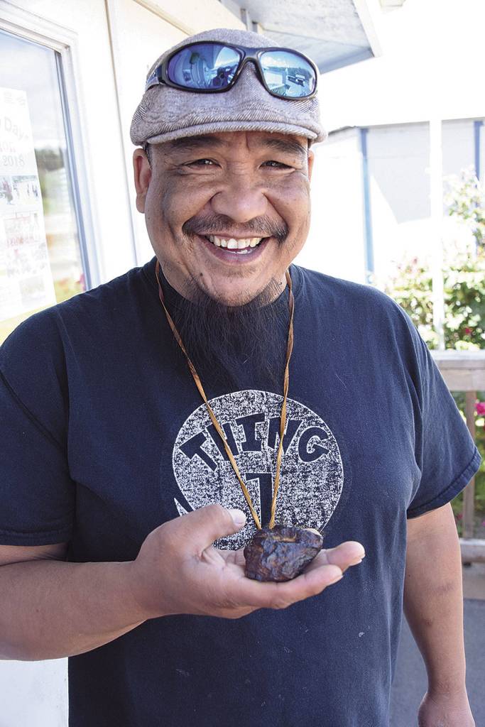 (Larry Workman) Franklin Delacruz holds what he thinks is a meteorite that he picked up along the coast of the Quinault Reservation. He thinks it could be from the March 7 meteorite fall.
