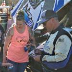 Sprint car winner Jay Cole, right, signs autographs for fans during Grays Harbor Raceways Fan Appreciation festivities on Saturday. (Photo by AR Racing Videos)