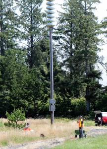 DAN HAMMOCK | THE DAILY WORLD                                Crews with the Department of Natural Resources test the ground near the southernmost tsunami siren on the Shoalwater Bay Indian Reservation July 18. This is the location chosen for the vertical tsunami evacuation tower, close to tribal housing.
