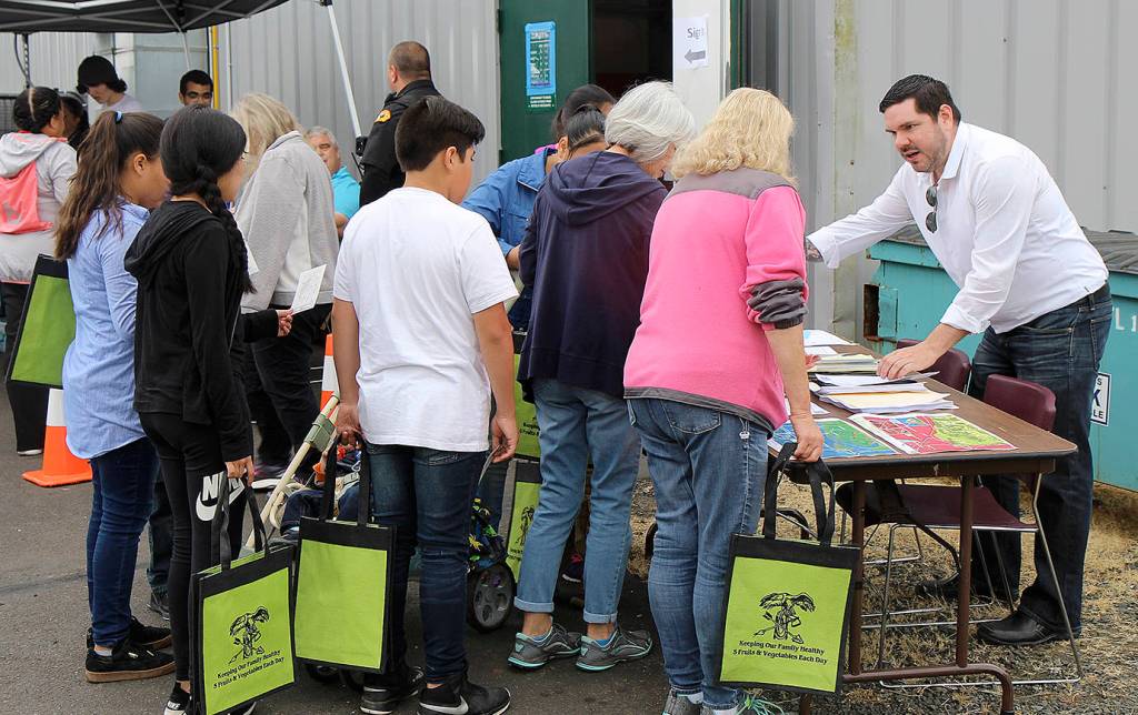 DAN HAMMOCK | THE DAILY WORLD                                The public was given reusable bags when they registered at the annual Yellow Brick Road health walk event on the Shoalwater Bay Indian Reservation near Tokeland July 18. They could fill the bag with goodies at more than a dozen vendors scattered through the area before heading back to the tribes gym for a taco bar lunch and presentation about the recently-announced federal grant to build a vertical tsunami tower.
