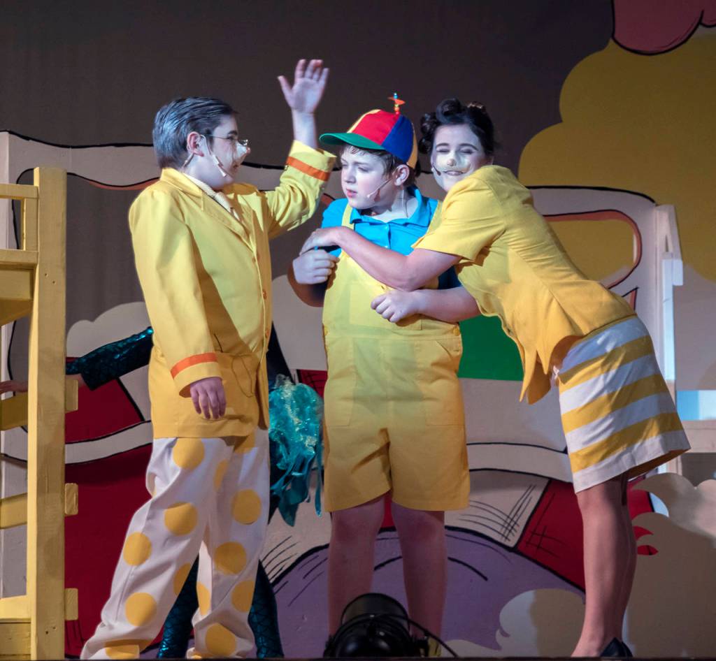 (Katherine Fowler) Mr. Mayor (Michael Turpin) talks to JoJo (Sam Dorsch) as Mrs. Mayor (Kathryn Thomas) hugs him.