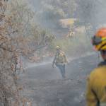 Firefighters from Los Angeles help stop the spread of a fire near homes in Redding, Calif., on Sunday. (Marcus Yam/Los Angeles Times)