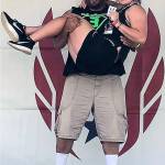 Team Evolution head coach Shaun Straka holds one of his athletes, Karlee Freeman, after Freeman won a Junior Olympic national championship in the discus throw in July. (Photo courtesy of Team Evolution Athletics)