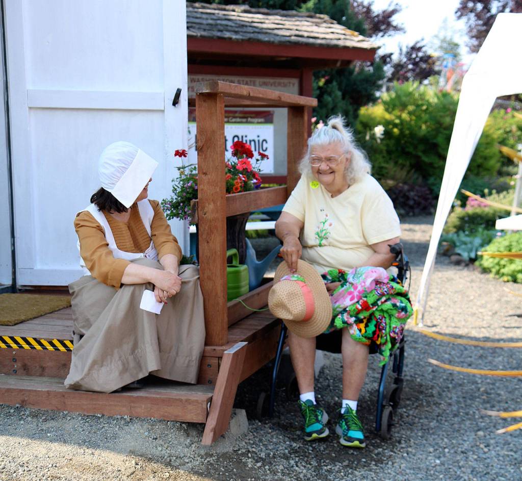 Michael Lang | The Vidette                                Colonial gardener Debbie Knight, left, of Aberdeen and and Leilani Linden of Hoquiam share a laugh Wednesday, Aug. 8, 2018, at the Grays Harbor County Fair in Elma. The fair runs through Sunday.