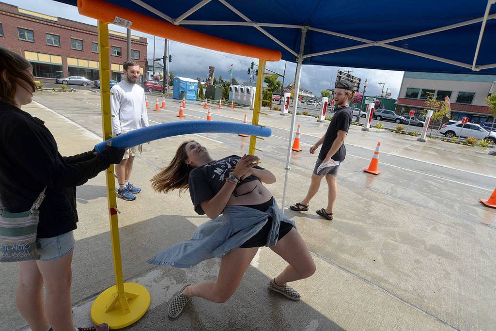Louis Krauss | The Daily World                                Lily Leta attempts limbo while her friends watch at Summerfest in downtown Aberdeen.