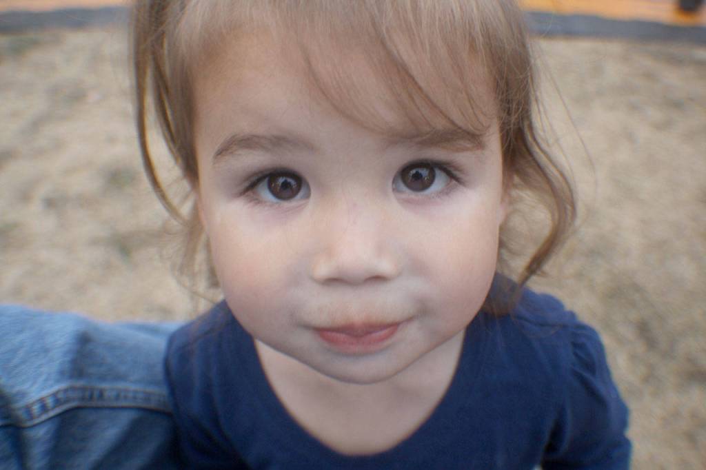 A young fairgoer checks out a reporters camera before running back to her mom Friday, Aug. 10, 2018, at the Grays Harbor County Fair in Elma.