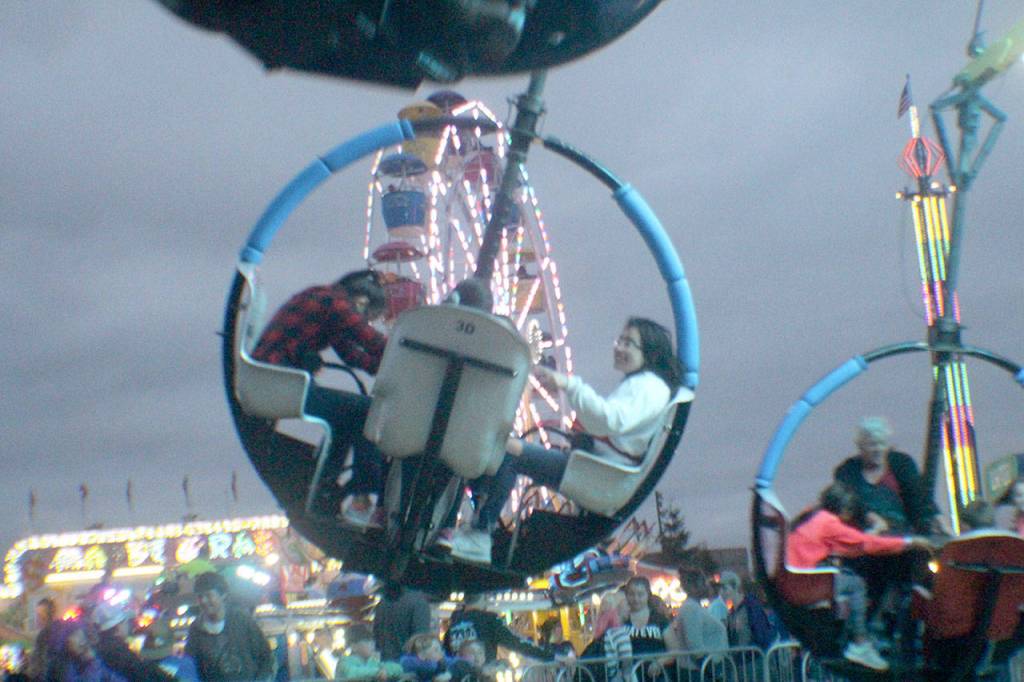 Fairgoers take a spin on the Tornado Friday, Aug. 10, 2018, at the Grays Harbor County Fair in Elma.