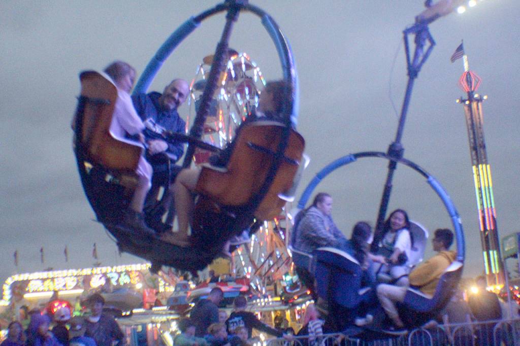 Fairgoers take a spin on the Tornado Friday, Aug. 10, 2018, at the Grays Harbor County Fair in Elma.