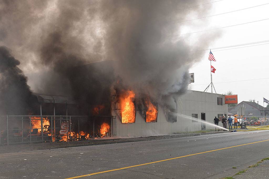 Louis Krauss | The Daily World                                Smoke emanates from the Harbor Saw Supply Inc. building on Simpson Avenue Monday afternoon.
