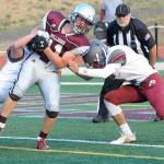 Levi Suddeerth, left and Antonio Garcia, right combine to tackle Brent Hollatz at the Jamboree on Friday, Aug. 24.(Hasani Grayson | The Daily World)