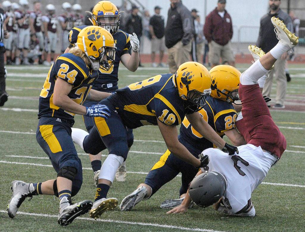 Aberdeens Enrique Edmonds (18) and Colton Faulkner (29) combine for a tackle on Hoquiams Antonio Garcia at Montesano at the Jamboree on Friday, Aug 24. (Hasani Grayson | The Daily World)