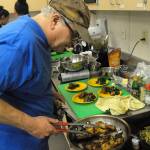 Louis Krauss | The Daily World                                Dave Haerle cooks during the United Way kickoff event Thursday in Aberdeen High School. Haerle, an editor at The Daily World, won first place at the event.