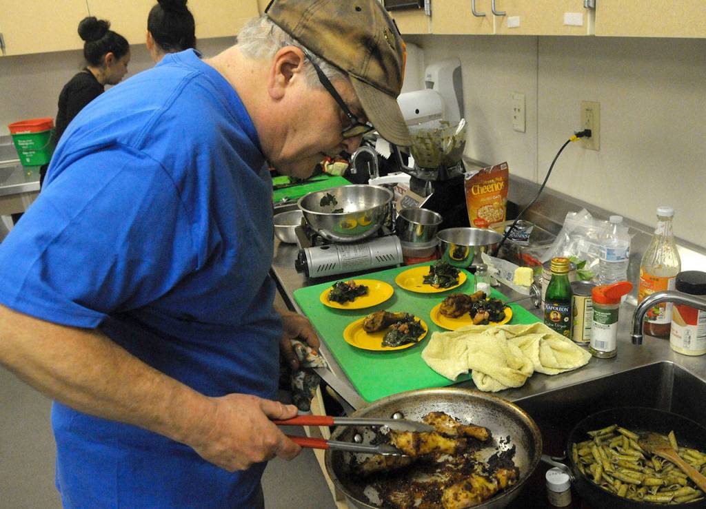 Louis Krauss | The Daily World                                Dave Haerle cooks during the United Way kickoff event Thursday in Aberdeen High School. Haerle, an editor at The Daily World, won first place at the event.