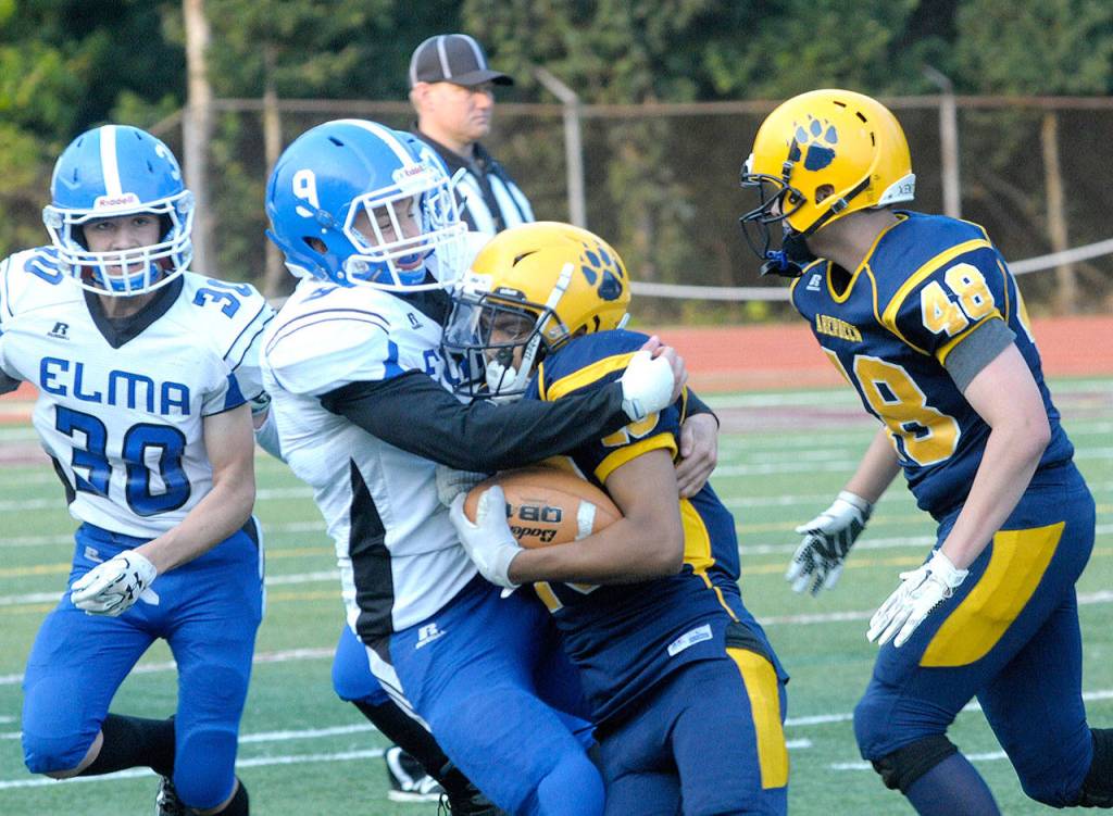 Elmas Anthony Hamilton tackles Jose Mercado on an outside run during the football jamboree on Aug 24. (Hasani Grayson | The Daily World)