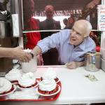GOP presidential candidate Sen. John McCain leans through a window at the order counter at Parkesdale Farm Market roadside stand, for some strawberry shortcake, in Plant City, Fla., in October of 2008, during a campaign stop on his bus tour across Florida. (Joe Burbank/Orlando Sentinel)
