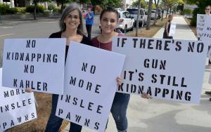 DAN HAMMOCK | THE DAILY WORLD                                AnnMarie Shuck (right) and her mother Holly welcomed about 30 protesters who set up shop across West Broadway Avenue from the Grays Harbor County Courthouse ahead of Judge Ray Kahlers sentencing of accused attempted kidnapper Isaac Gusman.