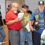 Elma Mayor Jim Sorensen, center holding papers and microphone, calls out the names of Vietnam War veterans or their family members during a ceremony Wednesday, Aug. 22, 2018, at the Fraternal Order of Eagles hall in Elma. Photo by Michael Lang, The Vidette