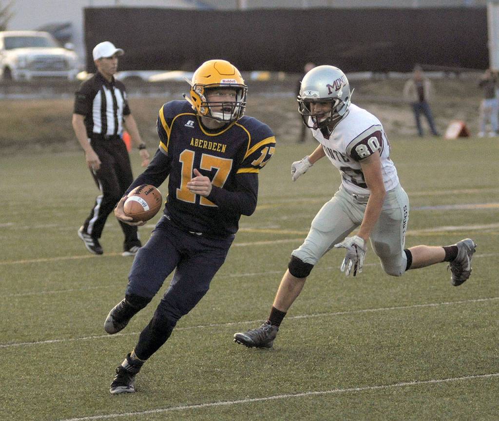 Aberdeens Ben Dublanko, left, rolls out of the pocket before scrambling down the sidelines against Montesano on Friday Sept, 7. (Hasani Grayson | The Daily World)