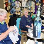 The Tamis Treasures booth at the 50th annual AAOS Arts & Crafts Festival included Tami Sperry-Shaws husband Glen Shaw, who was stitching away on a Halloween haunted house counted cross-stitch design. The couple came from Stanwood, WA, to participate in the Labor Day weekend event. Scott D. Johnston photo
