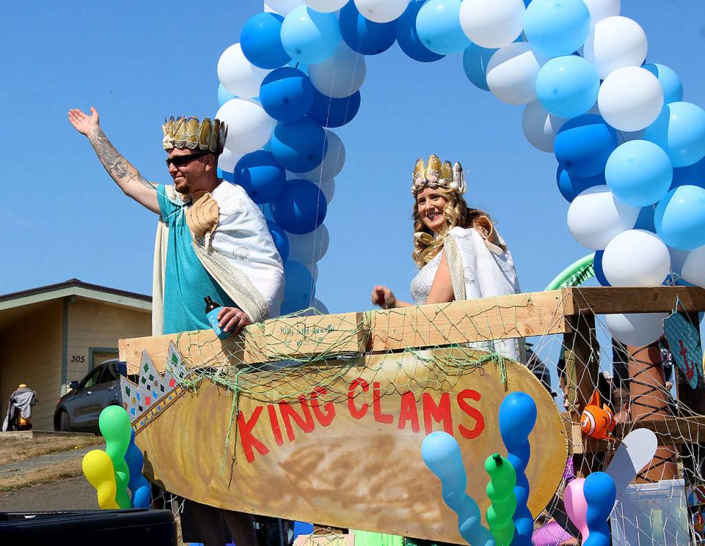 The King and Queen of Clams, Matt and Lisa Lockwood, at the annual Kelpers Parade aboard the Seaside Paradise float on Sunday entering downtown Pacific Beach.