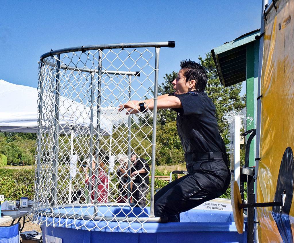 Ocean Shores Police Chief Neccie Logan took the plunge (again and again) at the dunking booth at the Paddle the Shores event held Saturday at Oyhut Bay Seaside Village and produced by the non-profit Ocean Shores Fresh Waterways Corp. Scott D. Johnston photo