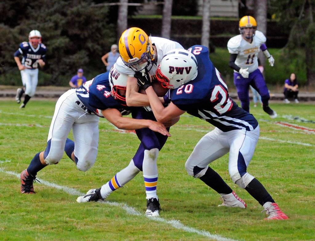 PWV defenders Kollin Jurek, left, and Sam Winter tackle Concrete receiver Devin Blankenship during the Titans 42-0 victory on Saturday in Menlo. (Ryan Sparks | The Daily World)