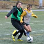 Alicia Cervantes, right, takes the ball away from Adrianna Huerta during at practice at Stewart Field on Monday. (Hasani Grayson | The Daily World)